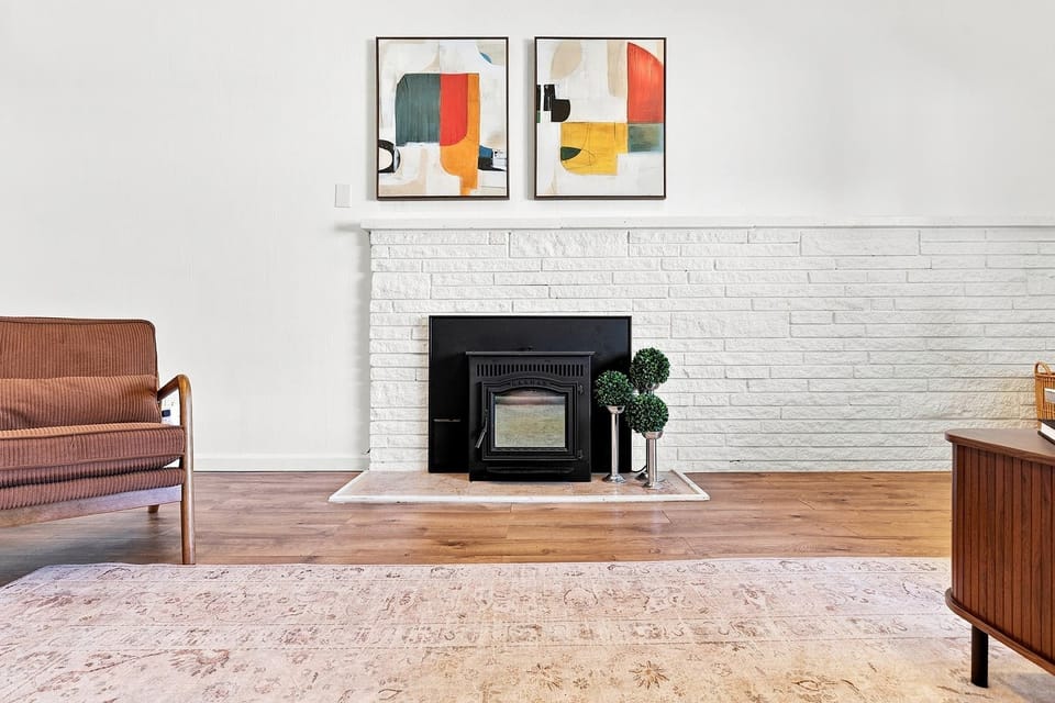 The fireplace forms a focal point in the living room.