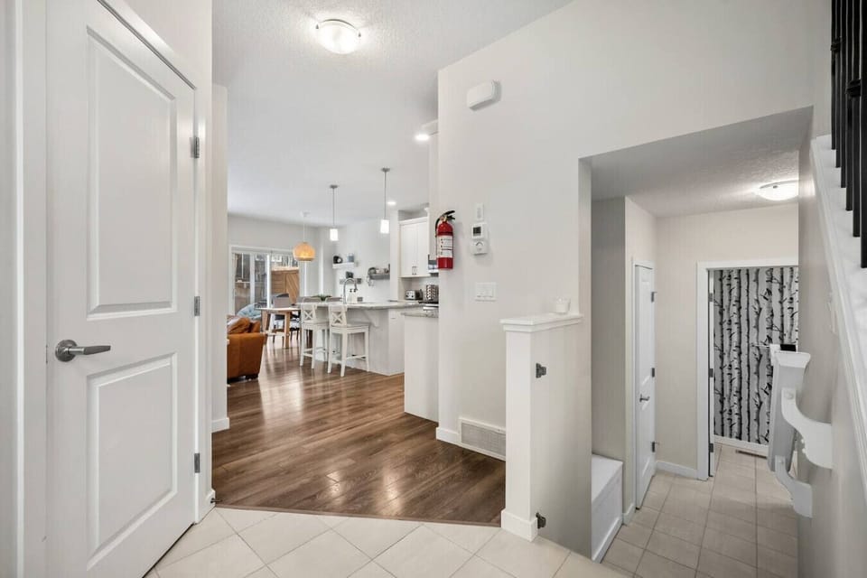 Main floor hallway with steps down to the half bathroom.