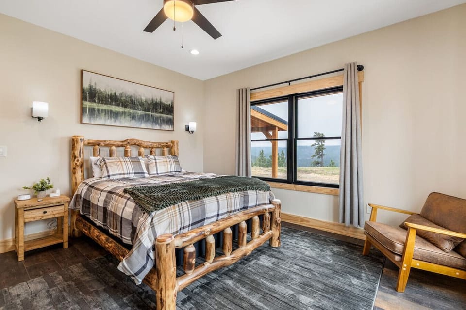Large windows with soft curtains and a cabin-inspired design create a welcoming retreat for rest and relaxation.