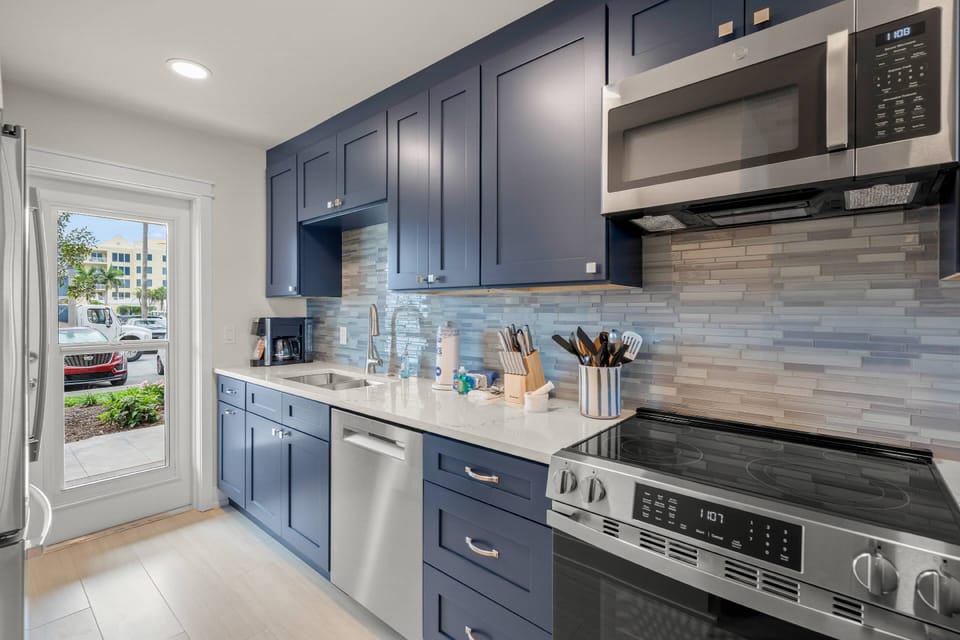 Prepare meals with ease in this bright, fully equipped coastal kitchen.