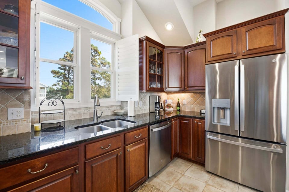 The gourmet kitchen is equipped with high-end GE appliances, perfect for preparing meals with ease.