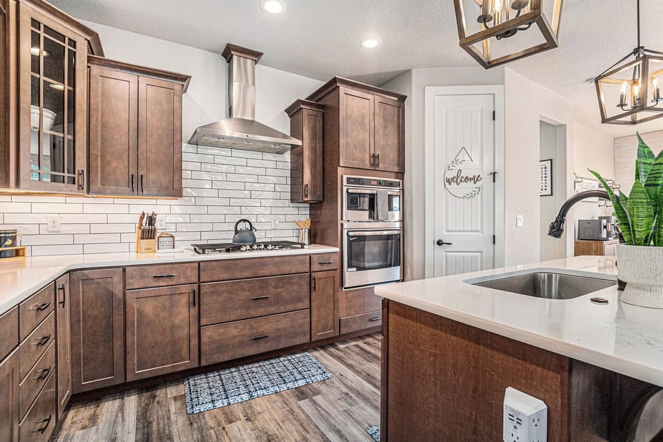 Gather in a warm, modern kitchen where every detail invites connection—cook, sip, and linger around the island as light pours in and the day unfolds. From morning coffee to evening meals, this space turns simple moments into lasting memories.
