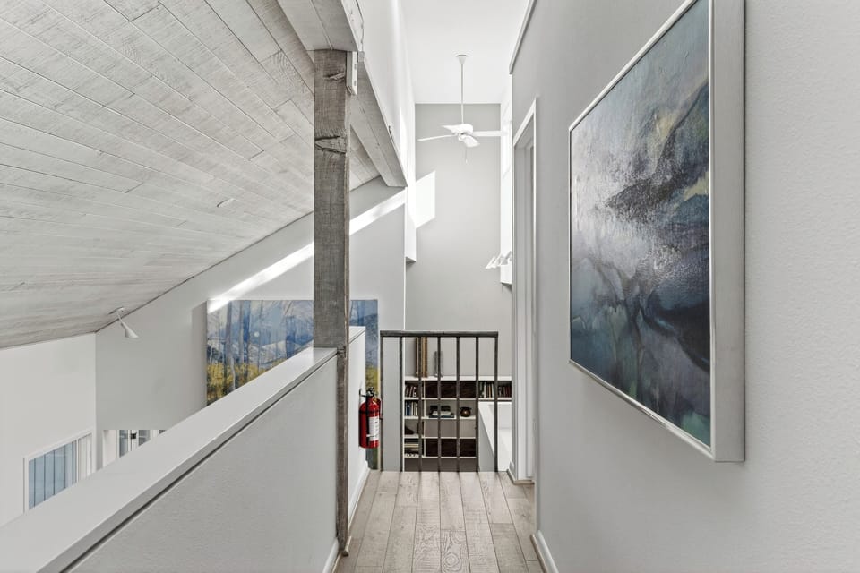 Modern architectural detail of the high-ceilinged stairwell and loft.