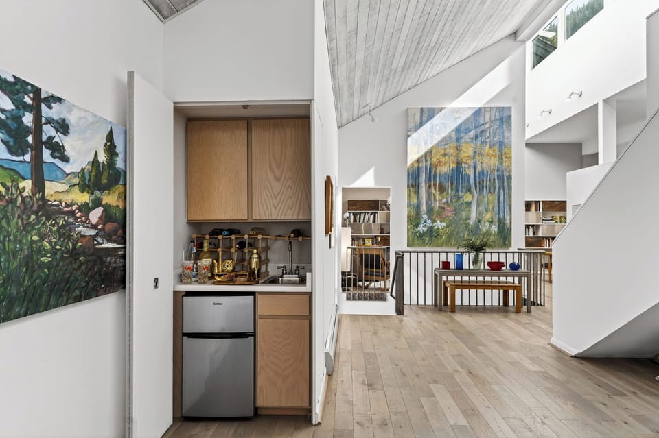 Featuring a mini-fridge and built-in storage/bar.