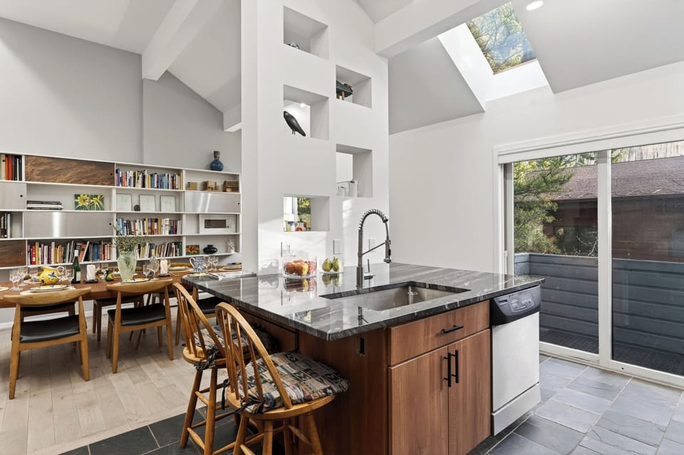 Gourmet kitchen island with a built-in sink and views of the dining room.