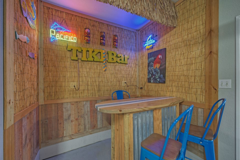 Game‑room garage with air hockey, ping pong, and a tiki‑style bar for laid‑back coastal fun.