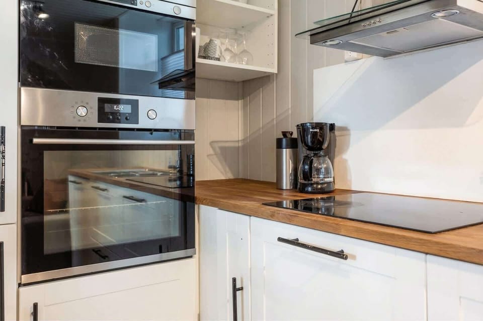 Kitchen detail - built-in oven, coffee maker, and induction cooktop