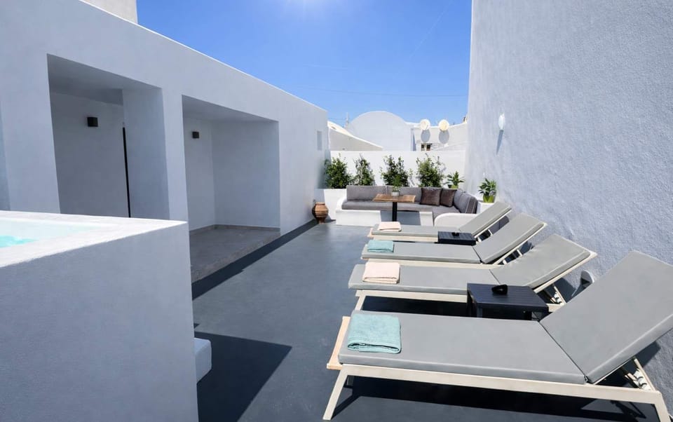 Spacious sun terrace with comfortable loungers and a cozy seating area for relaxing, dining, or soaking up the sun.
