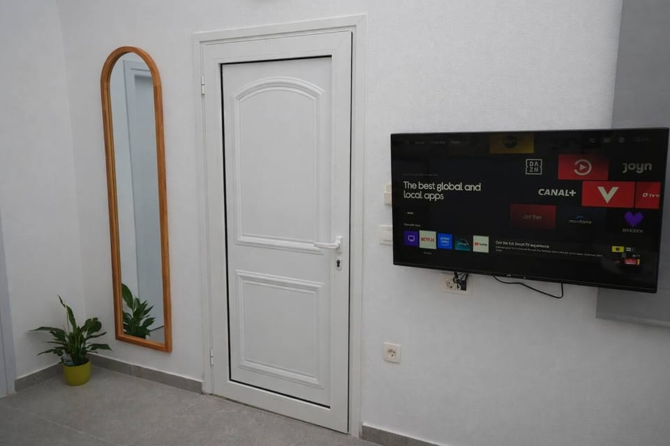 A wall-mounted TV adds comfort for evenings spent indoors.