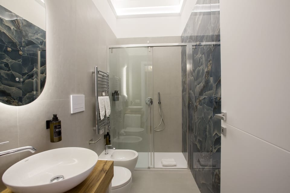 Luxury Quadruple Room, City View | Bathroom | Shower, hair dryer, towels, soap