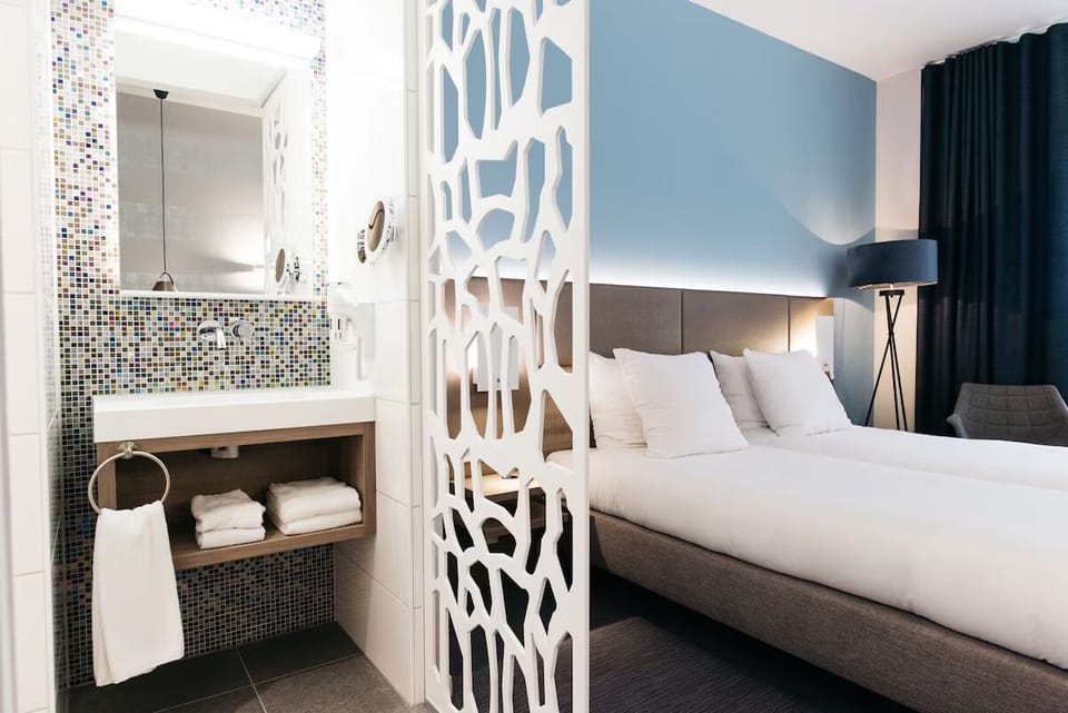 Refresh with fluffy towels and a sparkling mosaic vanity.
