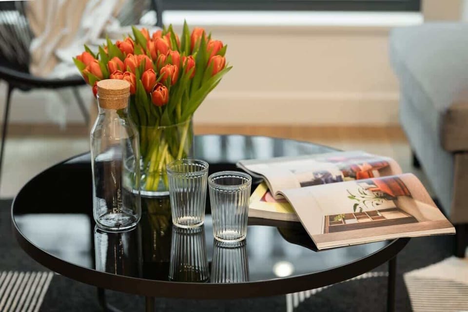 A close-up of a dining table set with flowers and glasses.