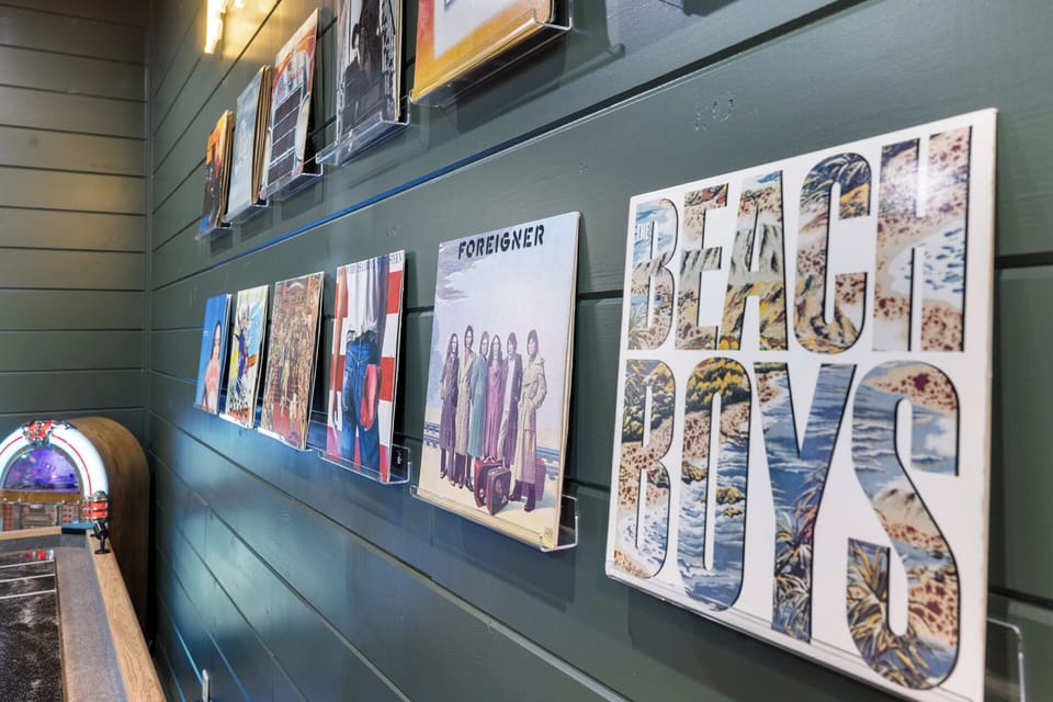 Curated record wall with jukebox/record player—perfect for setting the soundtrack to your stay