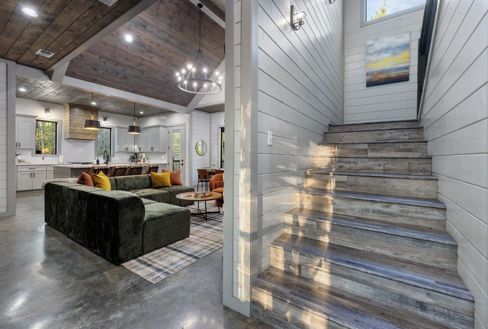 Stairs that lead up to 2 King Suites, the bunk room and two twin bed nook