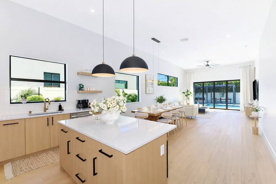 Very large, open area feeds the kitchen directly into the dining room with a large table and eight (8) chairs.