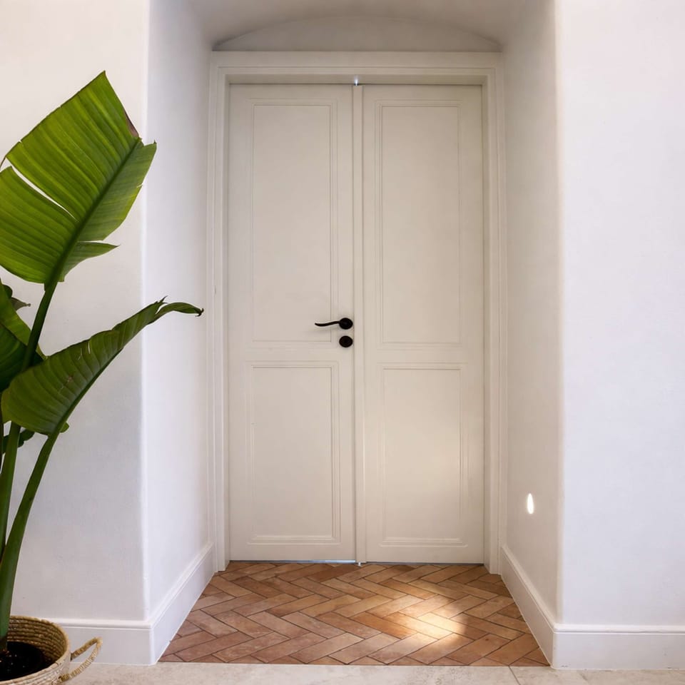 Sunlit hallway with minimalist design and natural textures, offering a warm and welcoming impression .