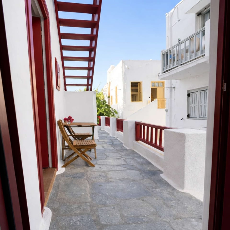 Charming exterior with traditional architecture, leading to private outdoor seating areas.