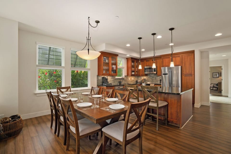 Your open-concept kitchen and dining area combines rich wood cabinetry with modern stainless appliances, perfect for preparing meals and gathering together.