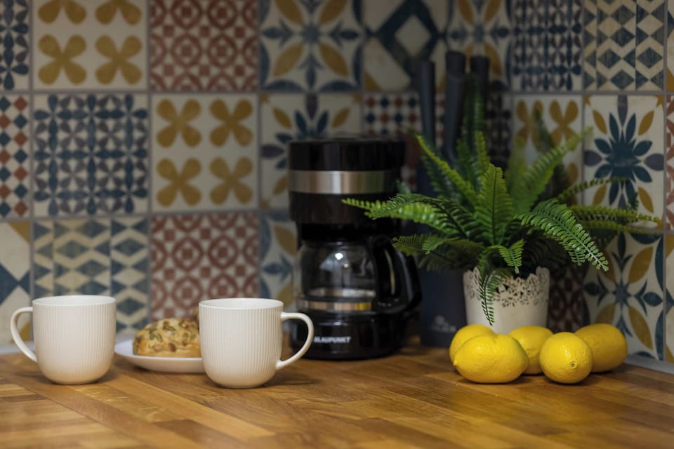 A kitchen detail with a patterned backsplash and small decor elements. Plants and accessories add character.