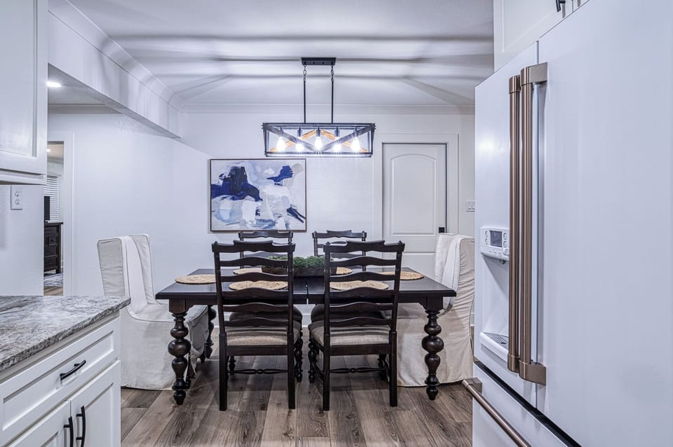 Gather around this elegant dining table where memorable meals and conversations await, with a stylish pendant light creating the perfect ambiance.