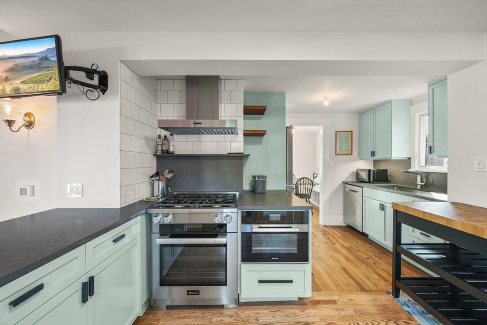Fully equipped with essentials, the kitchen offers easy access to the backyard deck, perfect for morning coffee or effortless entertaining.