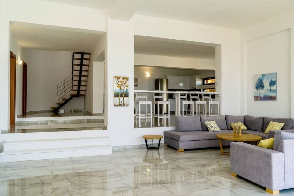 Spacious living area flowing into a sleek kitchen.