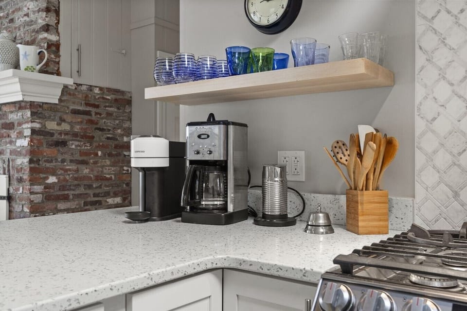 Coffee station featuring Nespresso, drip coffee, and a milk frother