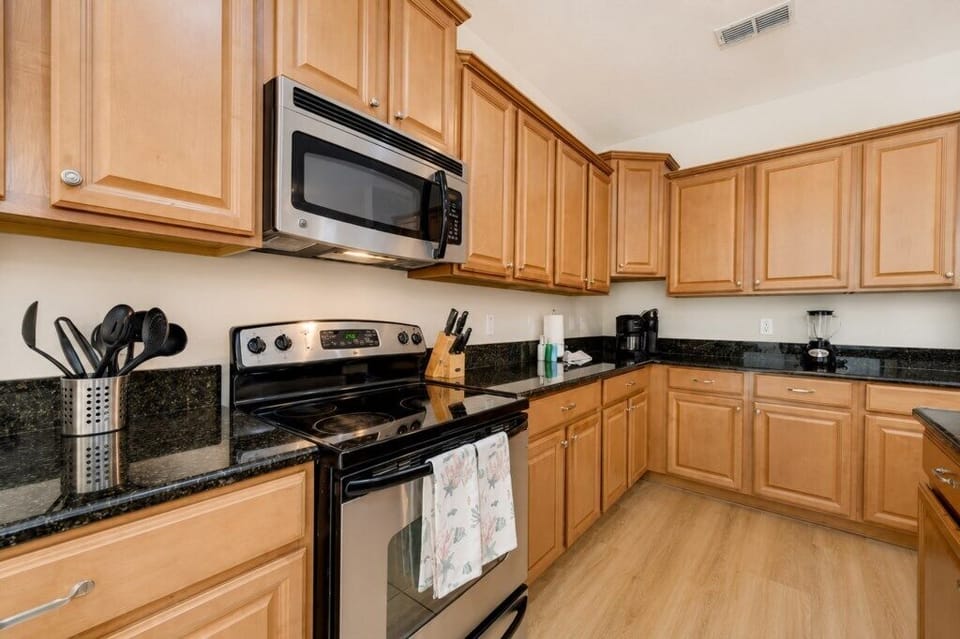KITCHEN:  Fully Equipped Kitchen with Side-by-Side Refrigerator, Microwave, Electric Stove, Oven, Dishwasher and Toaster