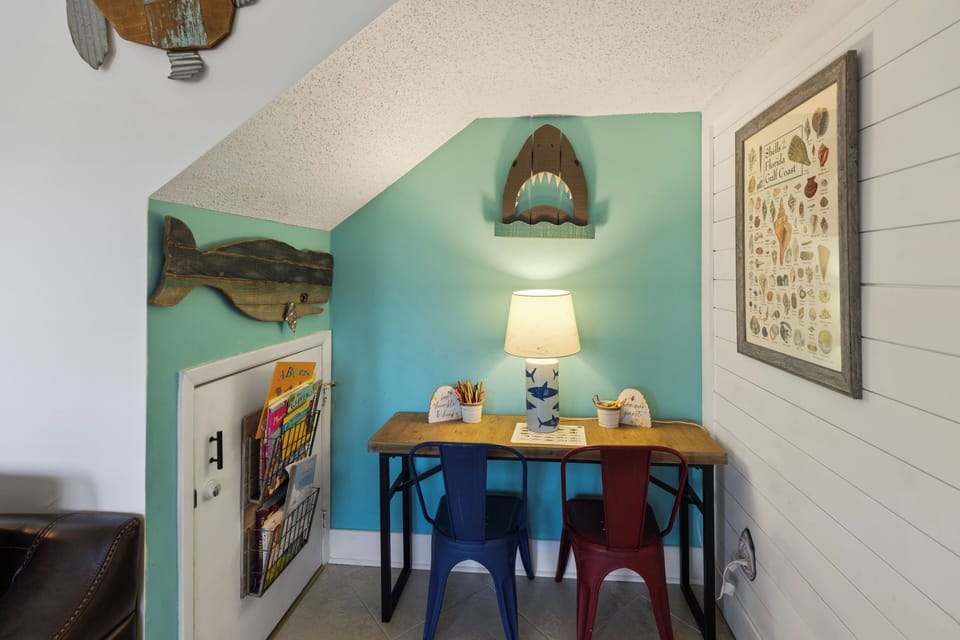Your creative corner awaits with ocean-themed decor and colorful seating—perfect for morning coffee or evening sketches.