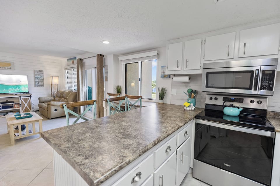 Cook with ease in your fully-equipped kitchen featuring granite countertops, stainless steel appliances, and an open layout that flows into your comfortable living space.