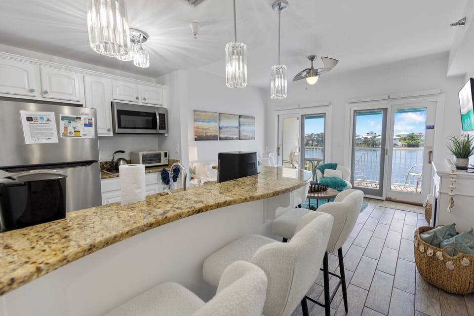 Your waterfront kitchen opens to stunning lake views through French doors leading to your private balcony—perfect for morning coffee with a view.