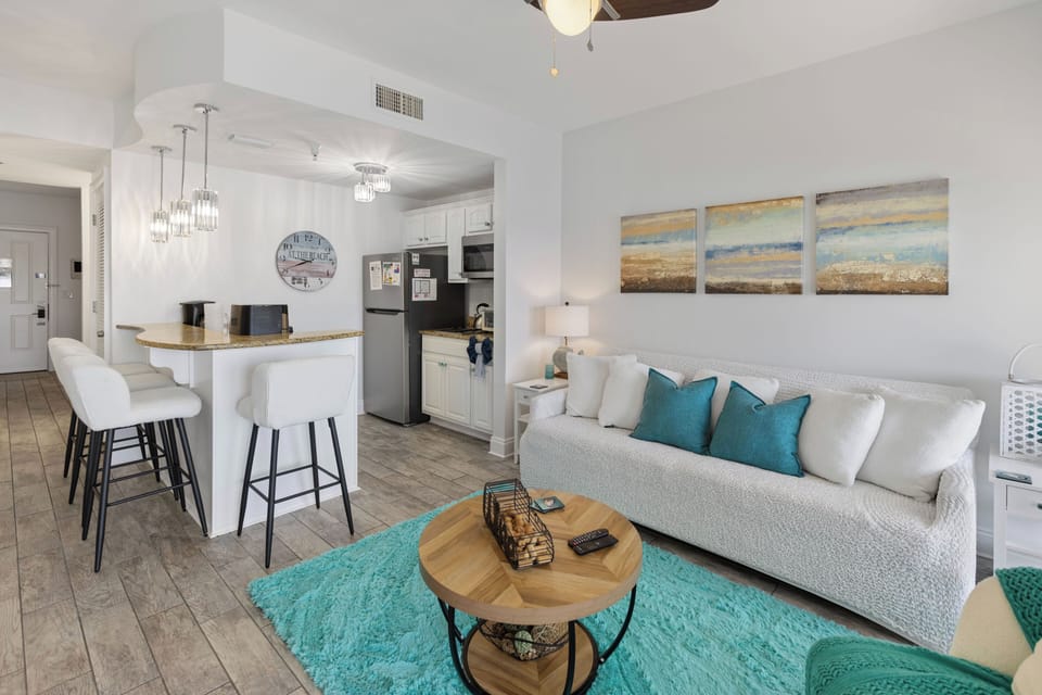 Your bright, open living space flows seamlessly into a fully equipped kitchen, perfect for relaxing after beach days.
