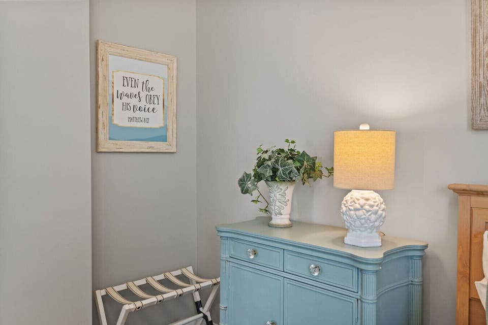 Coastal décor details with accent cabinet, soft lighting, and beach-inspired design