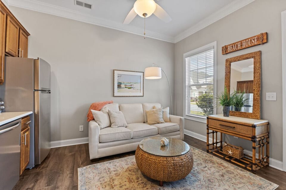 Bright coastal living room with cozy sofa, natural light, and beach house décor