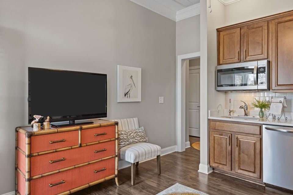 Cozy living area with smart TV, seating, and fully equipped kitchenette