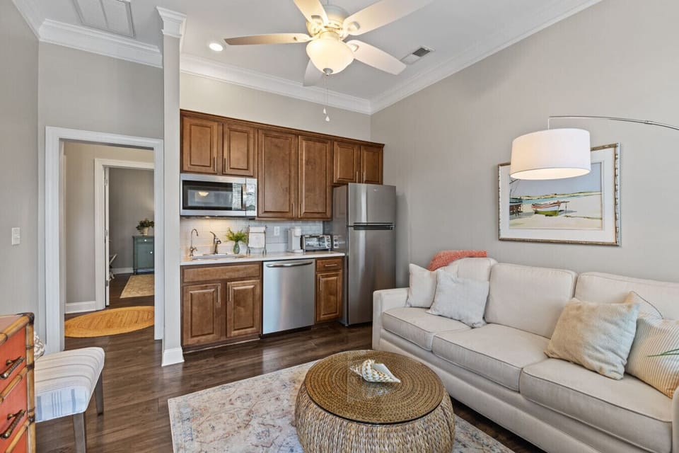 Open-concept living area with cozy seating and fully equipped kitchenette