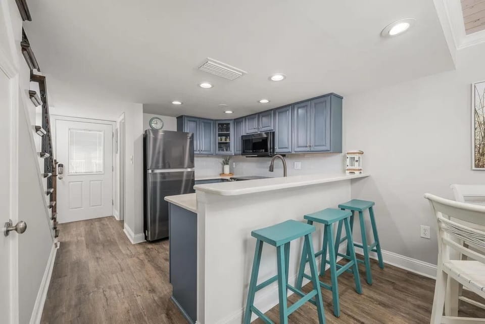 Bright kitchen with modern appliances and cozy breakfast bar seating