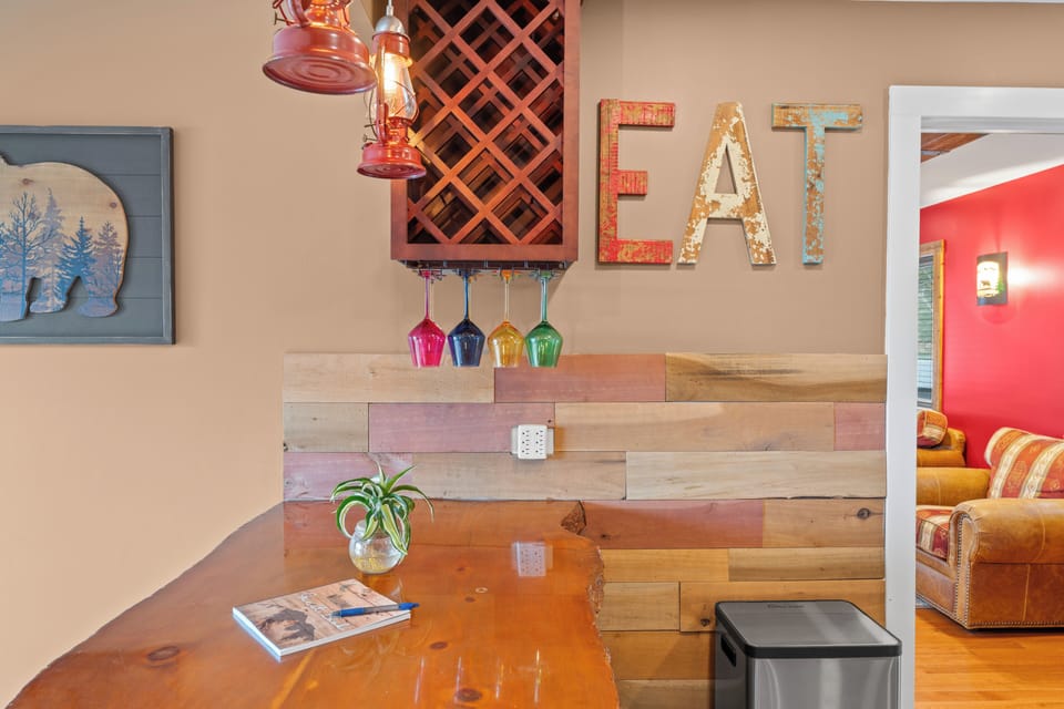 Rustic eat-in bar with wine rack, lantern lights, and a cozy living room view