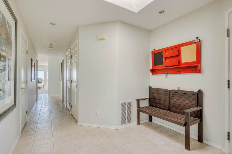Wide hallway with tiled floors and natural light—perfect for easy movement and a comfortable stay for families or groups.