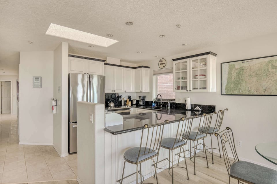 Start your morning with coffee at the breakfast bar or gather for casual meals in this open, inviting kitchen space.