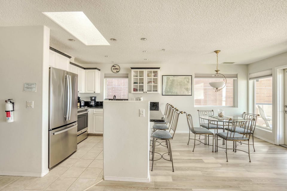 Bright, open kitchen and dining area with modern finishes, ample seating, and a welcoming space for shared meals.