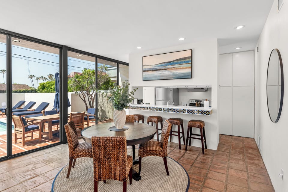 Dining space with views of the pool and patio.