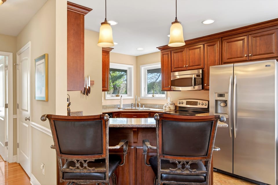 Kitchen with island seating for 2, dishwasher, and drip-style coffee maker