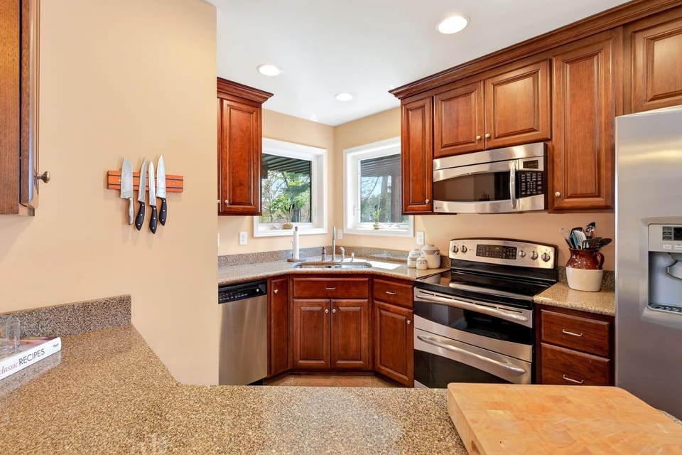 Kitchen with island seating for 2, dishwasher, and drip-style coffee maker