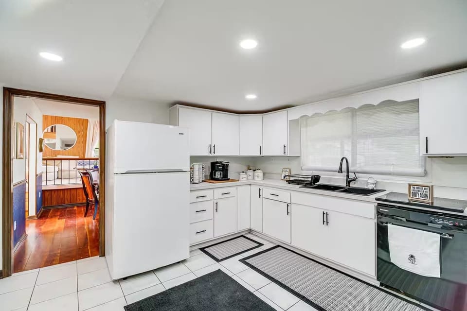 Bright kitchen with white cabinetry and modern appliances.