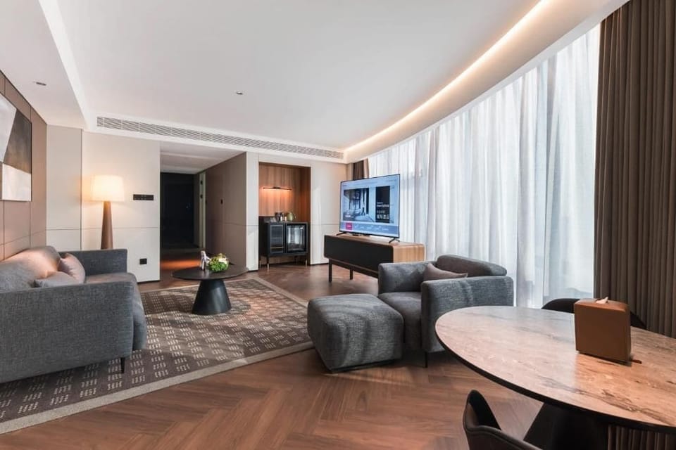 Luxury Suite, City View | Living area | 65-inch Smart TV with cable channels