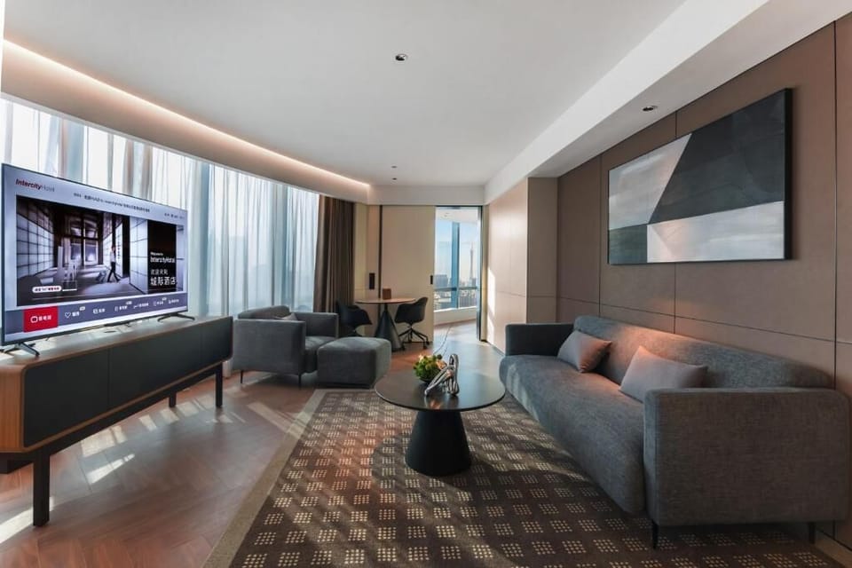 Luxury Suite, City View | Living area | 65-inch Smart TV with cable channels