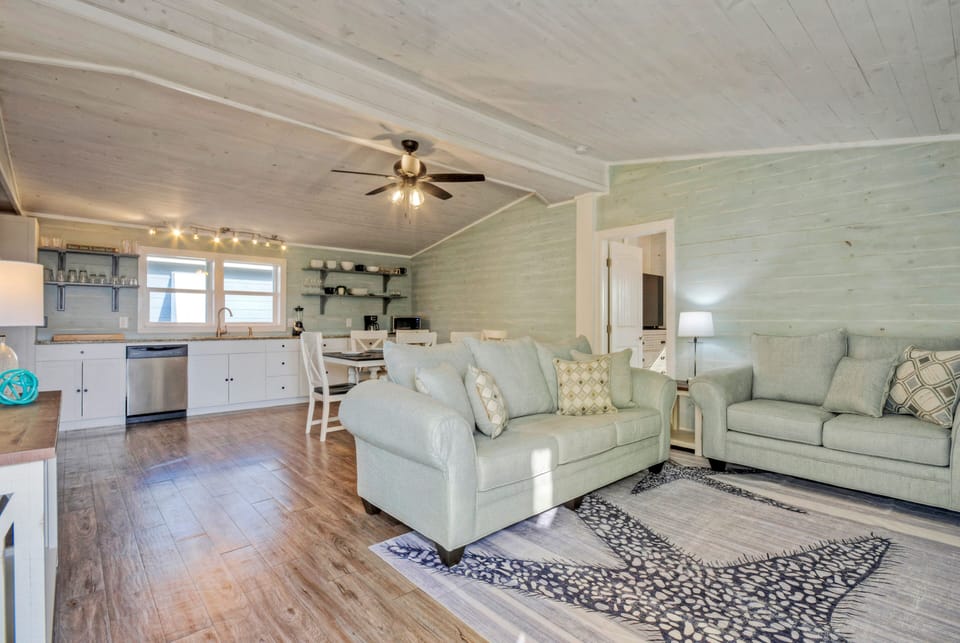 Comfortable open living space with coastal charm and an easy flow into the dining area and kitchen. (Tipsy Flipper)