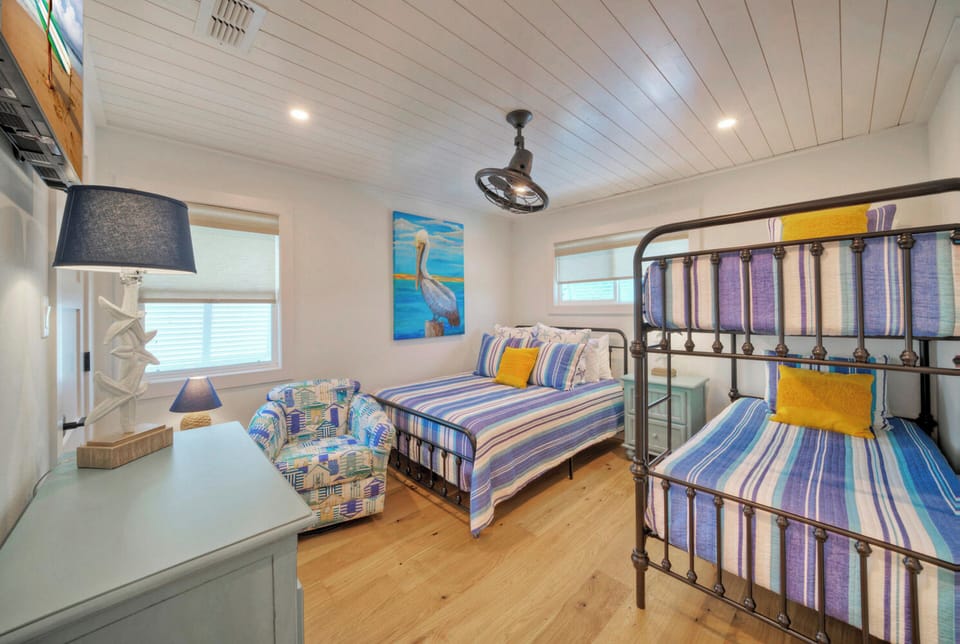 Bedroom 2 features a queen bed, twin bunk bed and a TV. (Boujee Pelican)