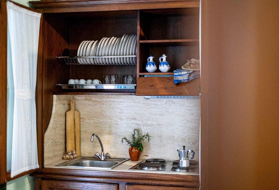Apartment, Garden View | Private kitchen | Fridge, stovetop, highchair, cookware/dishes/utensils